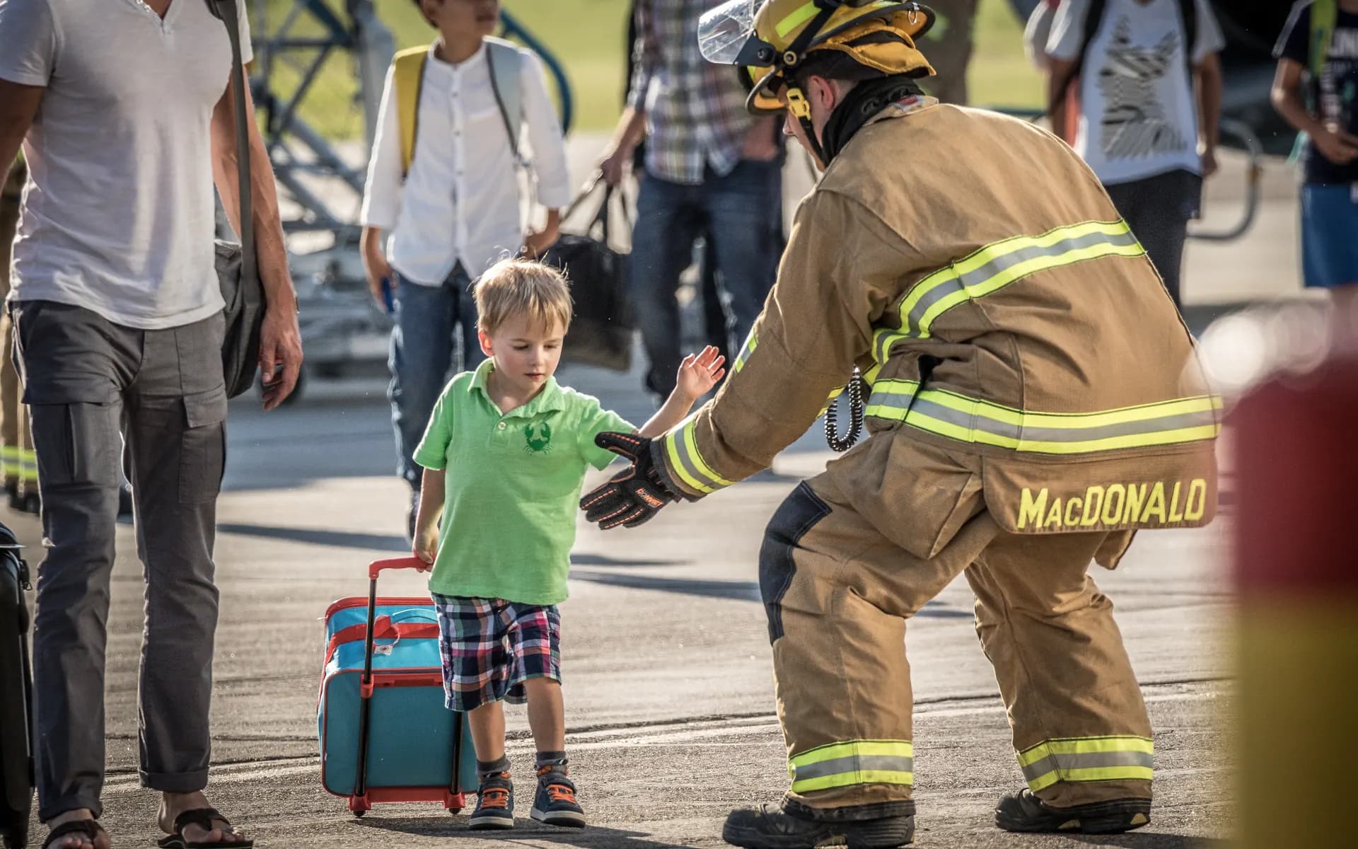A Your Lethbridge Firefighters firefighter greeting a child during a community event